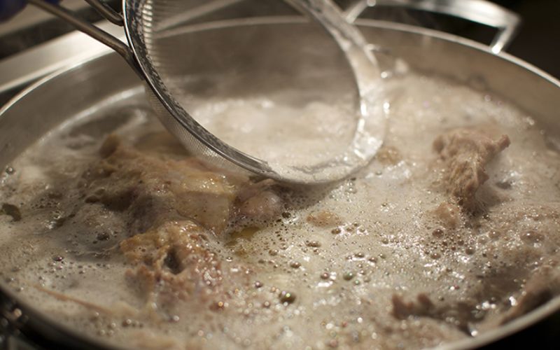 Keep the temperature at 185-195°F, skim regularly, and add aromatics at the right time